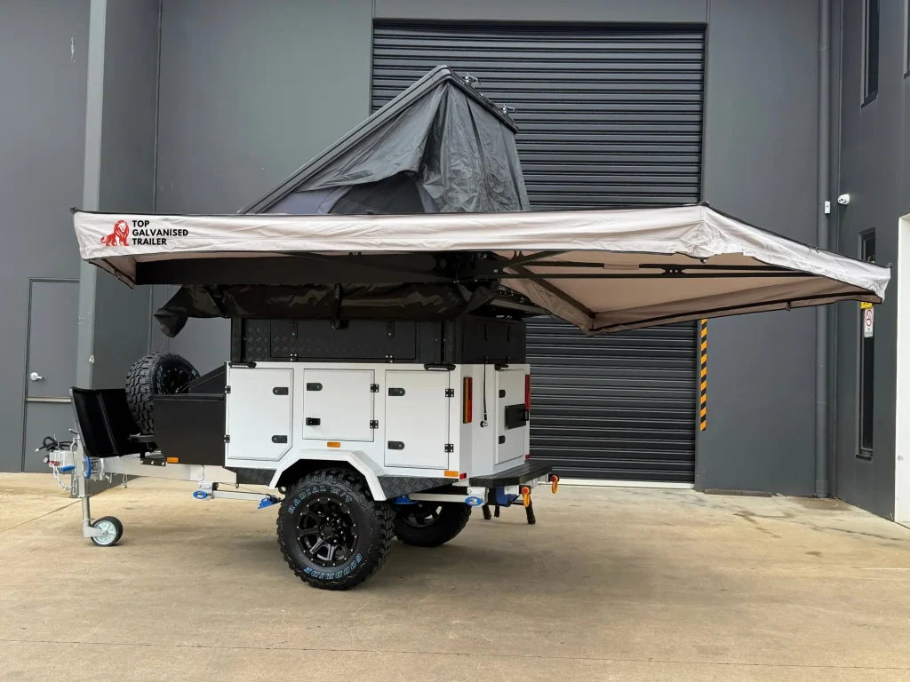 camper trailer with rooftop tent and awning