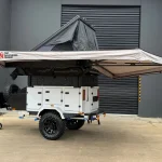 camper trailer with rooftop tent and awning