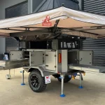 camper trailer with rooftop tent and awning